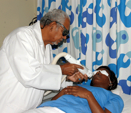 Dr. Neil Persadsingh using laser on dark skin patient